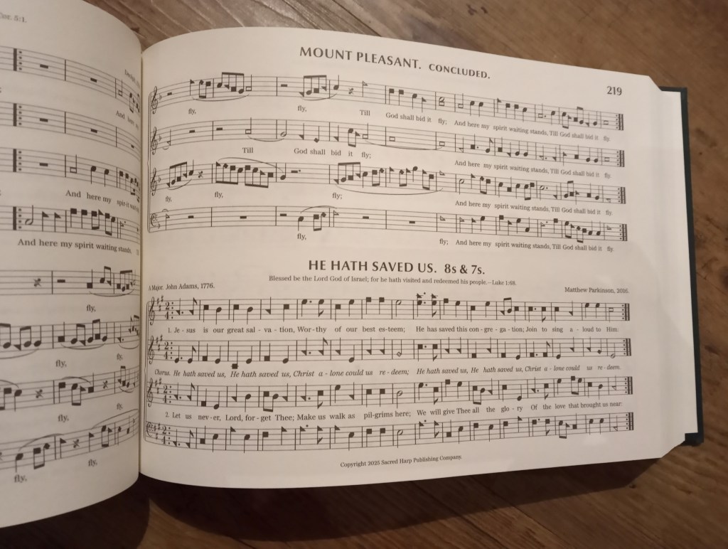 Page 219 of The Sacred Harp 2025 edition, showing Matthew's song He Hath Saved Us; part of the preceding song, Mount Pleasant, is visible above