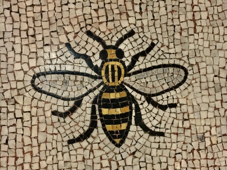 A mosaic of a worker bee. The symbol of Manchester and of industry.